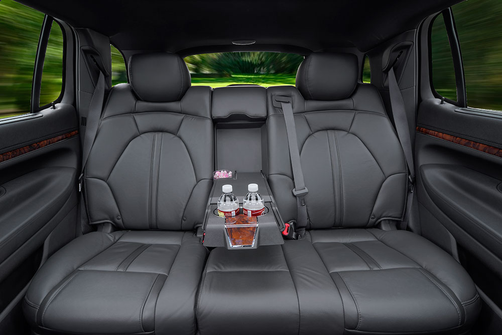 Back seat interior of a luxury sedan showcasing comfort and premium amenities