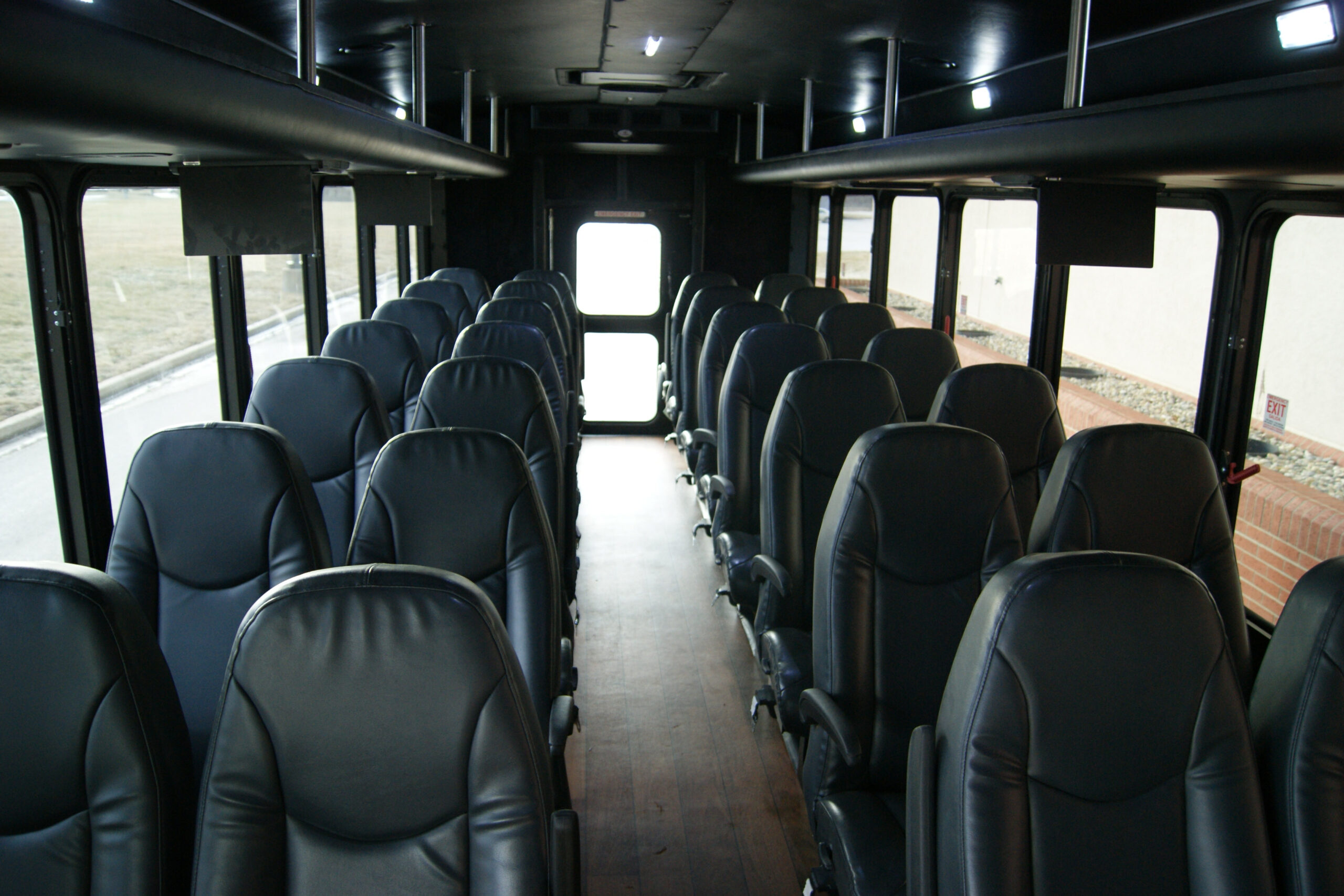 Interior of a luxury mini bus showcasing comfortable seating and premium amenities